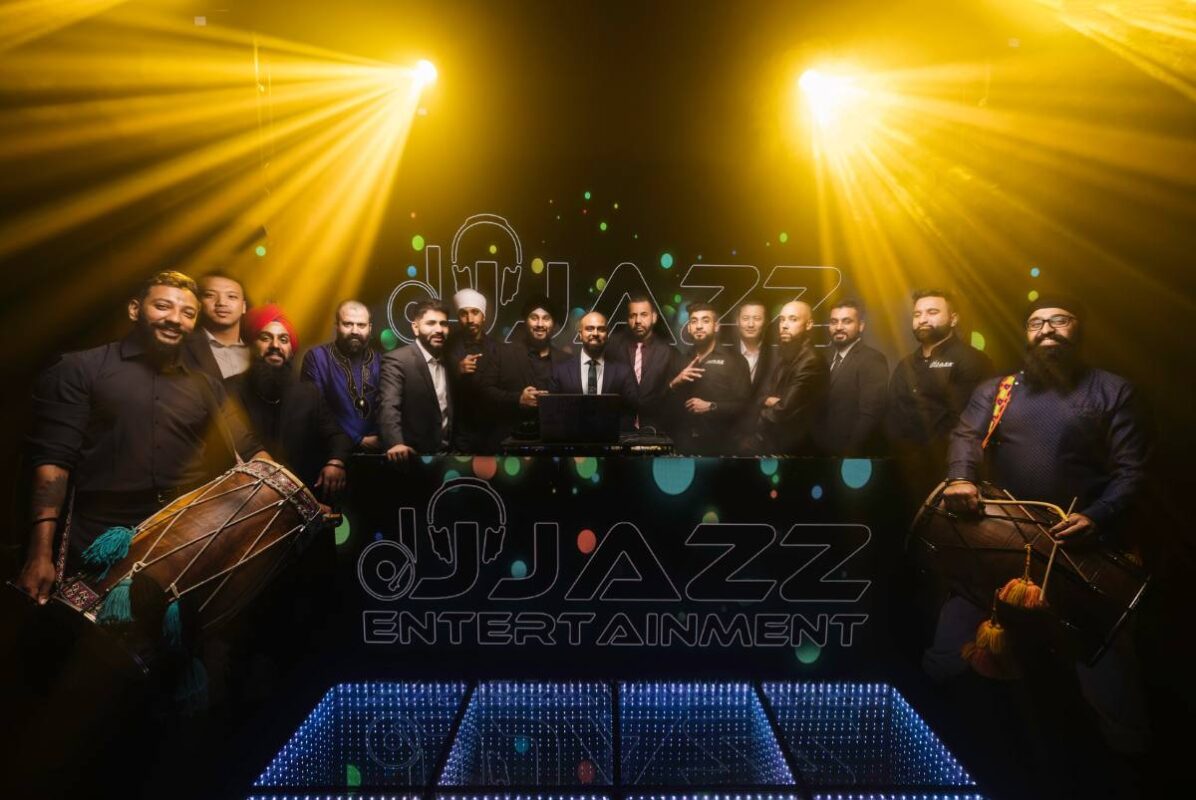 The DJ Jazz Entertainment DJ and dhol team on stage in Dallas